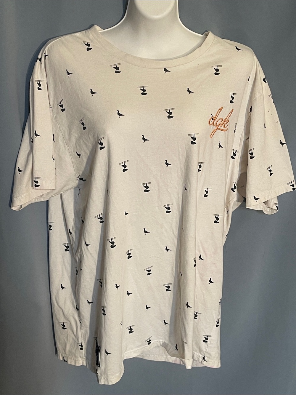 DGK Cream Short Sleeve Tee with Black Mini Print and Orange Script Logo
